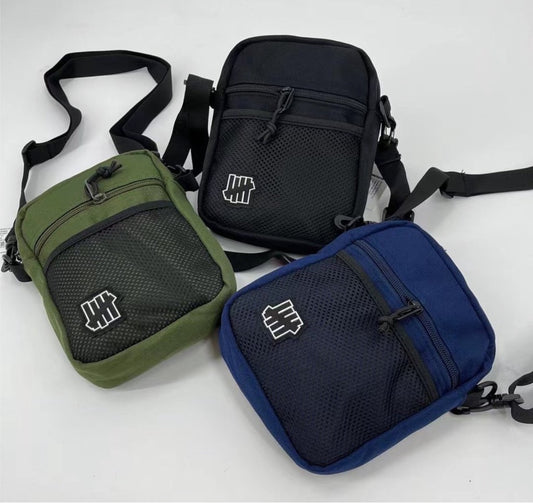 Undefeated cross body bag in green